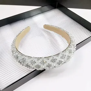 Close-up of sparkling white crystal headband with elegant diamond lattice beadwork