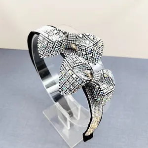 Macro shot of sparkling full crystal bow headband with hand-set rhinestones on black base