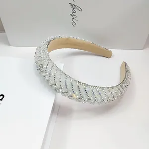 Close-up detail of luxurious wide headband featuring shimmering white pavé crystals