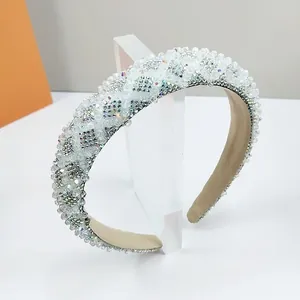 Detailed view of hand-sewn white crystals and beads on a luxury wide headband
