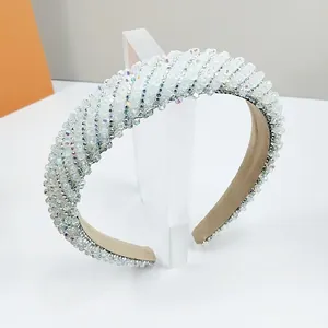 Macro shot of white sparkling crystal beads on handcrafted luxury headband with fabric lining
