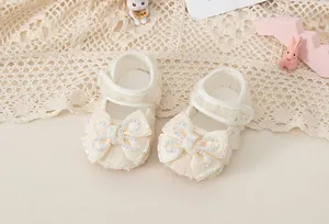 Detail of baby princess shoes with lace mesh and ribbon bow featuring shiny rhinestones