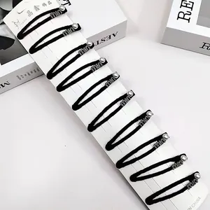 Lot de 10 barrettes noires avec perles argentées et strass sur carte de présentation