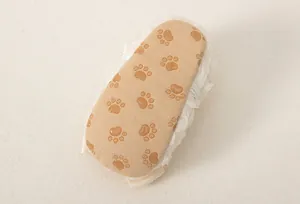 Close-up of soft non-slip baby shoe sole with brown paw prints and lace detail
