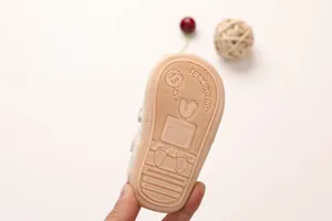Detailed view of baby sandal anti-slip rubber sole with size 13 and snail pattern
