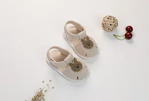 Close-up of baby cloth sandals with a plush rabbit decor and non-slip soft soles