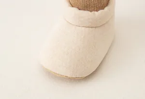 Detailed macro view of soft apricot knitted cotton fabric on infant walking shoes