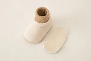 Detail view of baby soft sole walking shoe with breathable ribbed sock cuff and heel pull tab