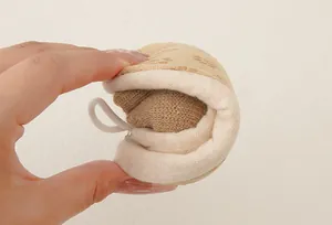 Close-up of flexible beige baby sock with brown paw-shaped anti-slip grip bottom