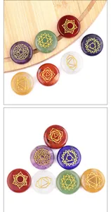 Macro detail of seven natural chakra stones with gold engraved meditation symbols