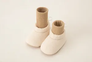 Detailed view of baby sock shoes featuring ribbed knit cuffs and soft anti-slip soles