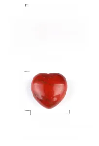 Macro detail of a 15mm polished red jasper heart stone showing natural mineral textures
