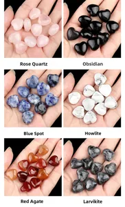Macro shot of assorted heart-shaped natural crystals including Rose Quartz and Obsidian