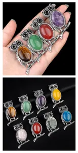 Macro display of eight natural stone owl pendants with vintage silver alloy details