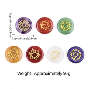 Set of 7 natural chakra healing stones with golden symbols in round disk shape