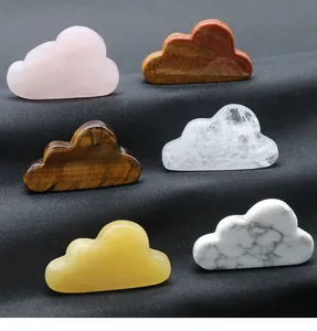 Macro view of six natural crystal clouds including rose quartz and tiger eye on black fabric