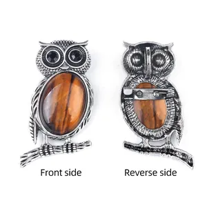 Front and back view of a vintage silver owl brooch with a large brown tiger eye stone