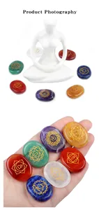 Detailed view of seven chakra energy stones with gold engraved meditation symbols
