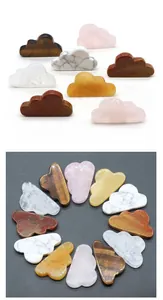 Macro detail of various natural crystal cloud carvings including rose quartz and tiger eye