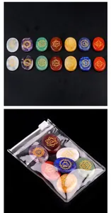 Macro view of seven chakra energy stones with golden symbols in a clear storage bag