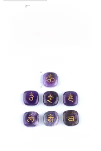 Detailed set of 7 amethyst chakra stones with golden engraved symbols for yoga meditation
