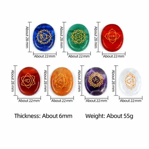 Set of 7 polished oval natural chakra crystals with gold engraved yoga symbols