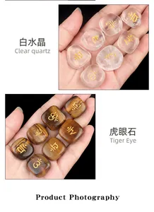 Detailed view of polished Clear Quartz and Tiger Eye stones with engraved gold symbols