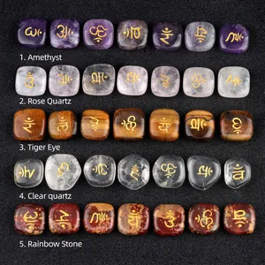 Polished amethyst and chakra crystal palm stones with gold engraved yoga symbols
