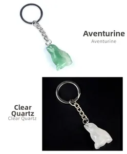 Detail of green aventurine and clear quartz crystal frog keychains with silver rings