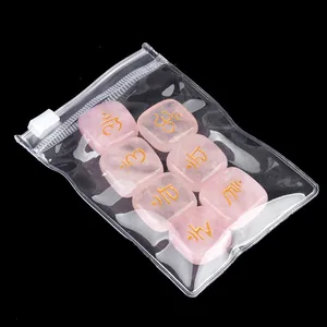 Set of 7 natural rose quartz palm stones with engraved gold chakra symbols in a PVC bag