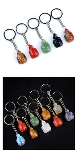 Detailed macro view of assorted natural stone turtle keychains with metal rings