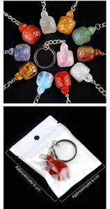 Detailed close-up of tortoise gemstone keychains with packaging size 8x6cm