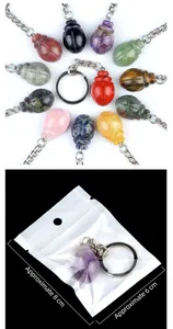 Detail of beetle-shaped crystal keychain and its packaging with dimensions labeled