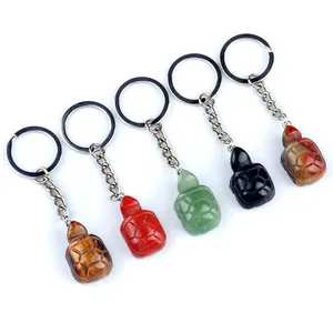 Set of five carved crystal turtle keychains in tiger eye and natural gemstones