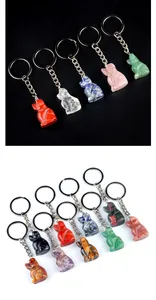 Macro detail of various natural gemstone animal pendants including quartz and obsidian