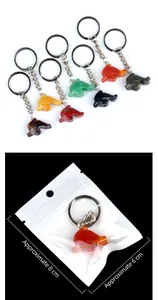 Detailed view of assorted natural stone dolphin keychains in multiple vibrant colors
