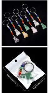 Macro shot of colorful natural stone bird charms with chakra beads and keychains