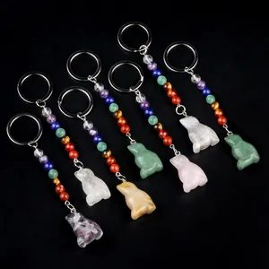 Chakra bird keychains with natural stones and healing crystals on dark background