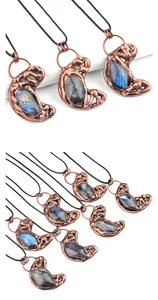 Detail of vintage copper moon pendant with glowing blue labradorite gemstone inlay