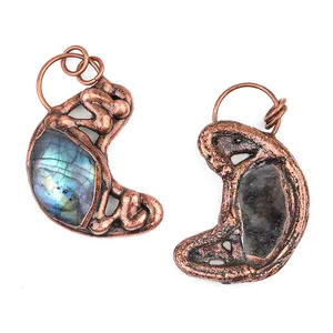 Natural Labradorite stone pendant with blue fire and vintage copper filigree on white background