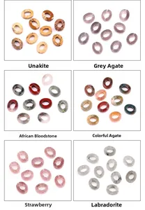 Close-up of assorted natural oval gemstone donuts including Unakite and Agate for DIY jewelry