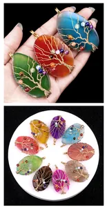 Macro detail of handmade wire wrapped tree of life pendants with colorful agate stones