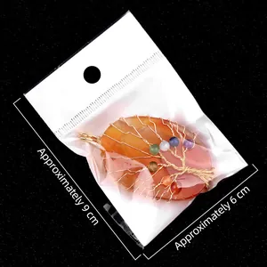 Handmade wire wrapped tree of life pendant featuring colorful agate and gold wire finish