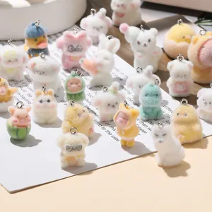 Close-up of colorful flocked animal charms with metal rings for DIY accessories