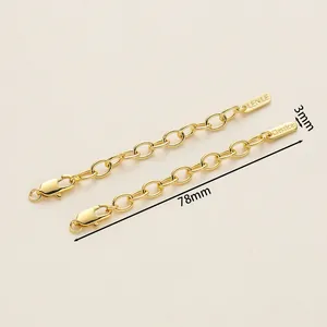Detail of 18K gold plated extension chains with lobster clasps and engraved metal tags