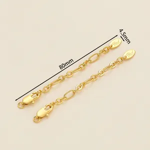 Detail of 18K gold-plated necklace extender chain with lobster clasp and oval metal tag