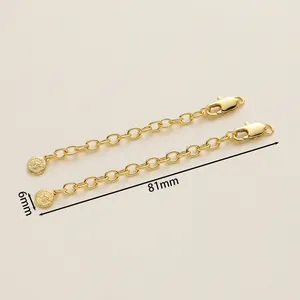Detailed view of 18K gold-plated extender chain with lobster clasp and round tag