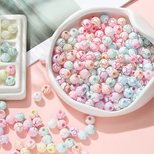 Macro detail of mixed macaron color acrylic beads with unique crackle patterns and pre-drilled holes