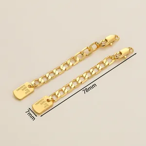 Close-up of 18K gold-plated extension chain with lobster clasp and engraved name tag