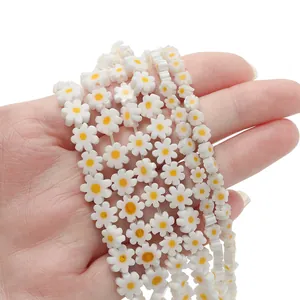 Handheld view of French style daisy glass beads for DIY necklaces and bracelets